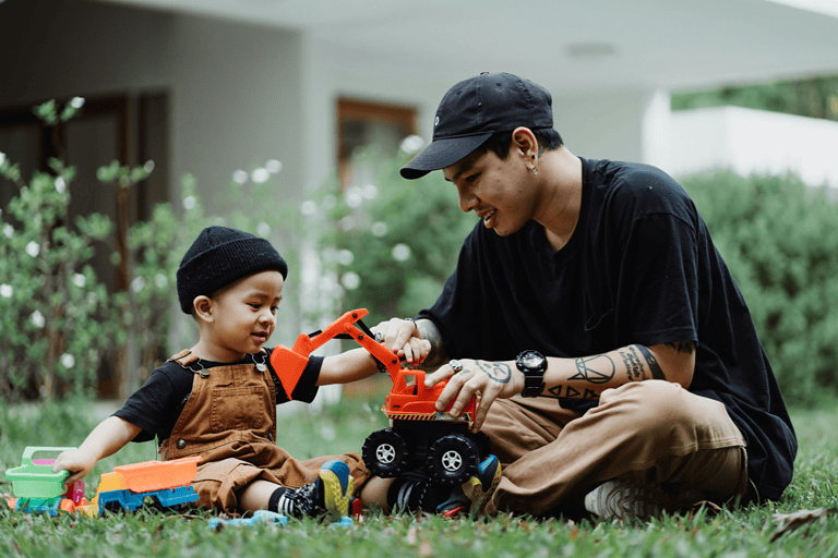 A toddler learns about problem solving while playing outdoors with parent.